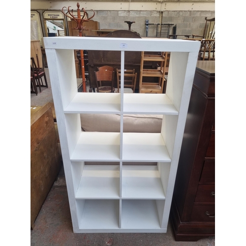 100 - An IKEA white painted eight section cube shelving unit