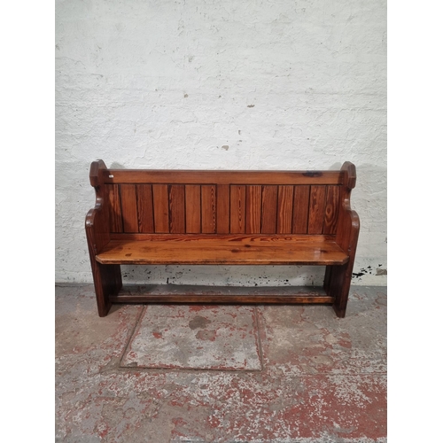 101 - A late 19th century pitch pine church pew - approx. 93cm high x 153cm wide x 41cm deep