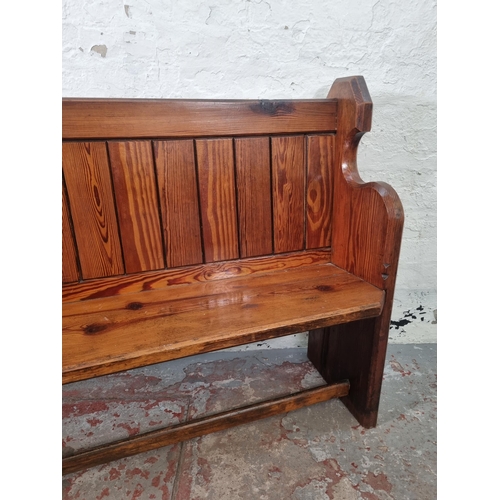 101 - A late 19th century pitch pine church pew - approx. 93cm high x 153cm wide x 41cm deep