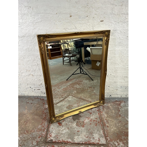 12 - A gilt framed bevelled edge wall mirror 
- approx. 90cm high x 115cm wide