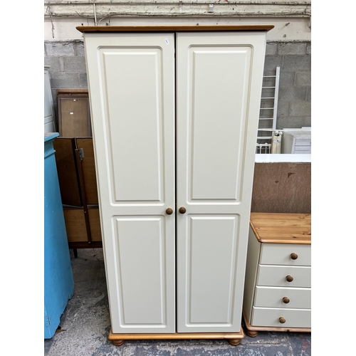 33 - A pine and white painted three piece bedroom suite comprising two chests of drawers - approx. 74cm h... 