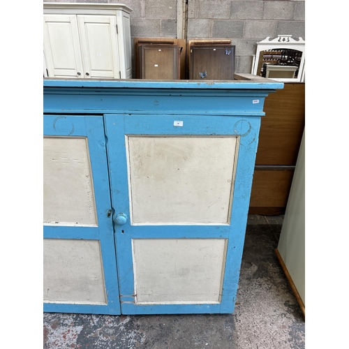 34 - A Victorian painted pine two door housekeeper's cupboard - approx. 133cm high x 140cm wide x 53cm de... 