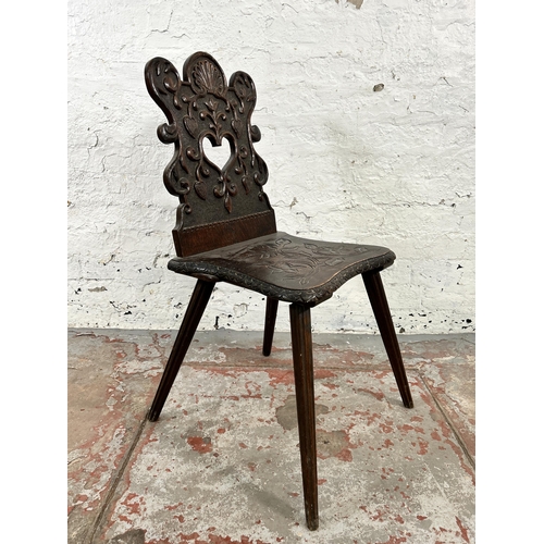 42 - A carved oak hall chair - approx. 84cm high x 39cm wide x 48cm deep