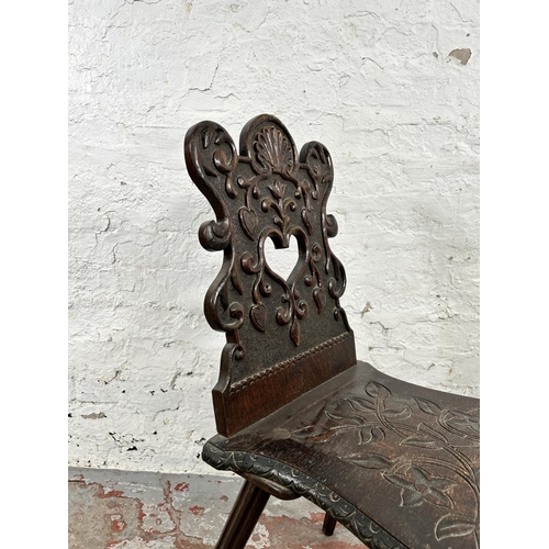 42 - A carved oak hall chair - approx. 84cm high x 39cm wide x 48cm deep