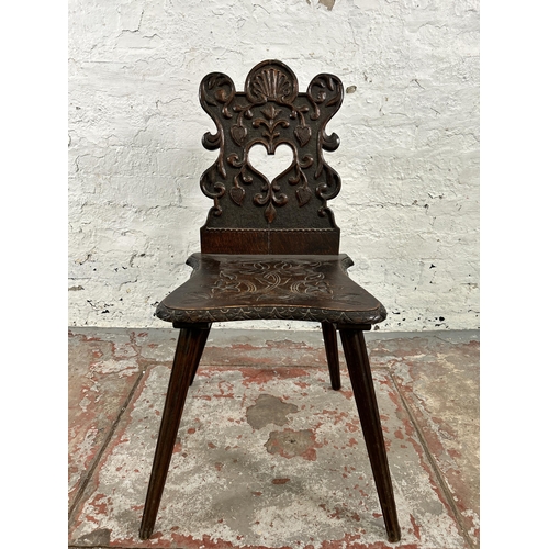 42 - A carved oak hall chair - approx. 84cm high x 39cm wide x 48cm deep