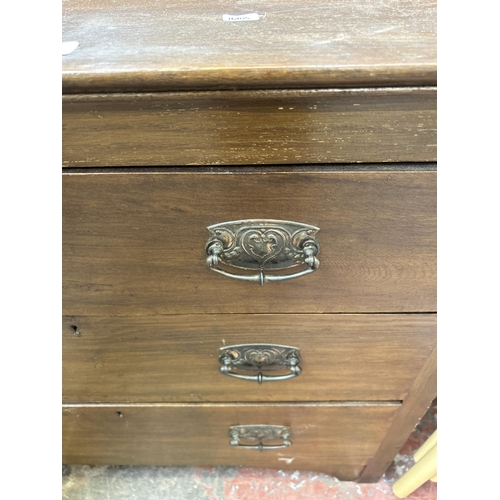 58 - An Edwardian oak chest of three drawers