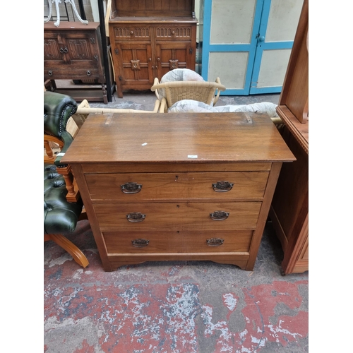 69 - An Edwardian oak chest of three drawers