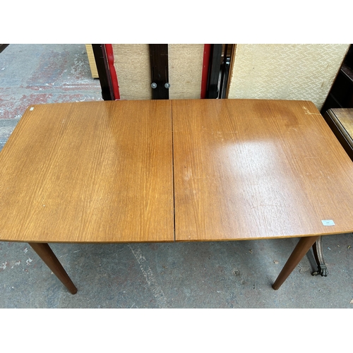 196 - A 1960s A.H. McIntosh & Co Ltd teak extending dining table - approx. 74cm high x 83cm wide x 147cm l... 