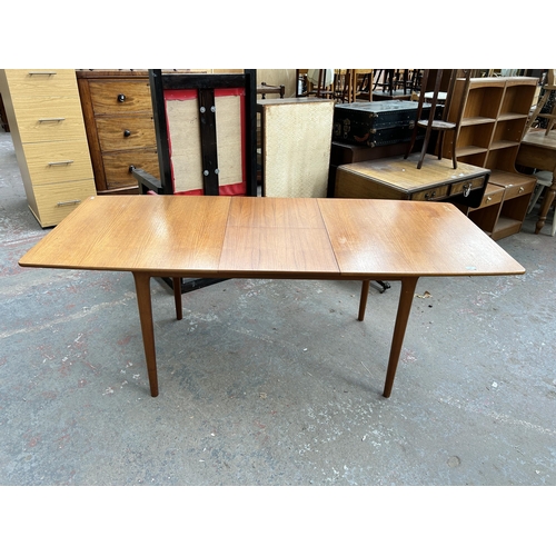 196 - A 1960s A.H. McIntosh & Co Ltd teak extending dining table - approx. 74cm high x 83cm wide x 147cm l... 