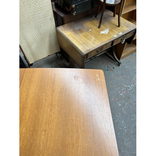 196 - A 1960s A.H. McIntosh & Co Ltd teak extending dining table - approx. 74cm high x 83cm wide x 147cm l... 