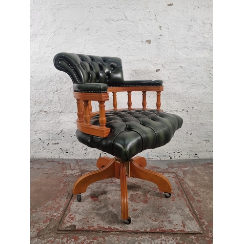 70 - A yew wood and green leather Chesterfield captain's swivel desk chair