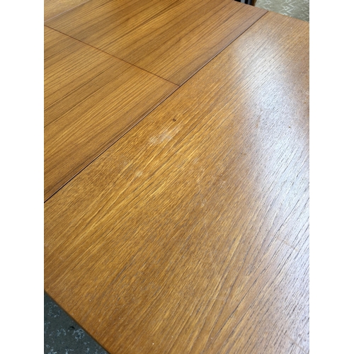 196 - A 1960s A.H. McIntosh & Co Ltd teak extending dining table - approx. 74cm high x 83cm wide x 147cm l... 