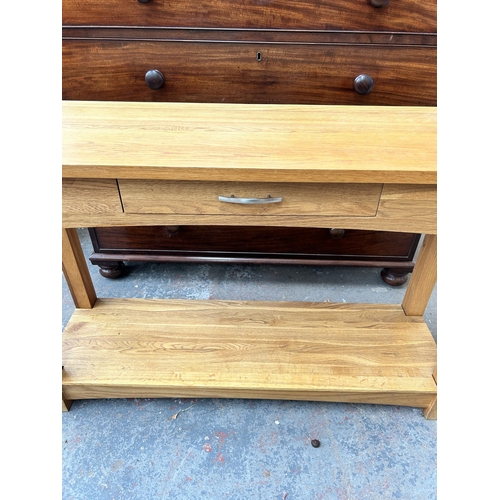 197 - A modern oak two tier single drawer console table - approx. 74cm high x 117cm wide x 36cm deep