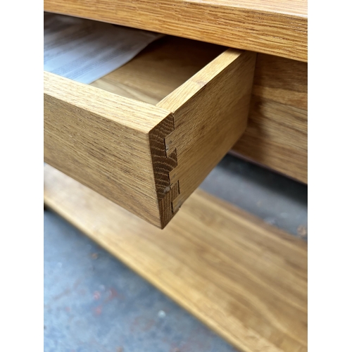 197 - A modern oak two tier single drawer console table - approx. 74cm high x 117cm wide x 36cm deep