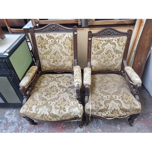 78 - A pair of Victorian carved mahogany and floral upholstered his and hers armchairs