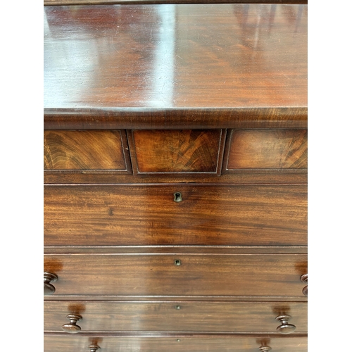 200 - An early 19th century mahogany chest of drawers with two secret drawers and turned supports - approx... 