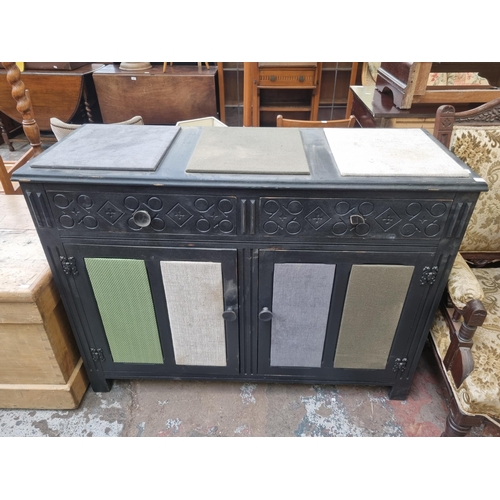 79 - A black painted and fabric upholstered sideboard