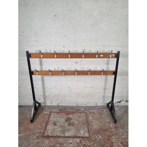 83 - A mid 20th century beech and black metal free standing school coat rack - approx. 125cm high x 154cm... 