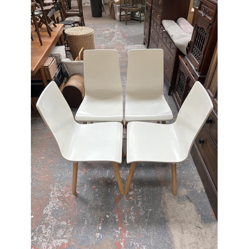 203 - Four modern white painted and beech dining chairs