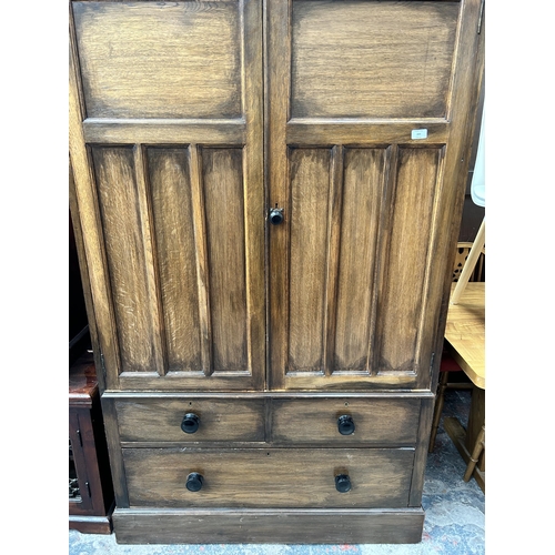 204 - A late 19th/early 20th century oak panelled double wardrobe with fitted interior - approx. 187cm hig... 