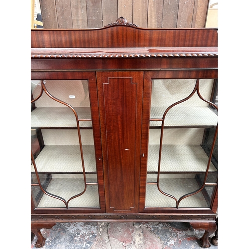 216 - An Edwardian Chippendale revival mahogany two door display cabinet with ball and claw supports - app... 