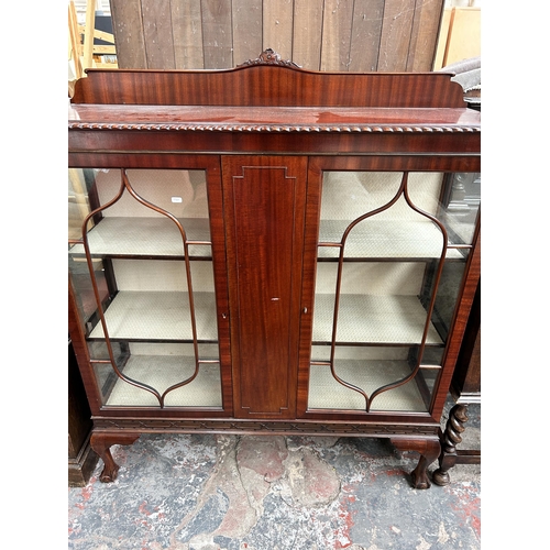 216 - An Edwardian Chippendale revival mahogany two door display cabinet with ball and claw supports - app... 