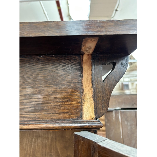 217 - An Arts & Crafts oak bookcase with two leaded and stained glass doors and copper hinges - approx. 19... 