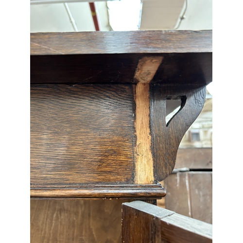 217 - An Arts & Crafts oak bookcase with two leaded and stained glass doors and copper hinges - approx. 19... 