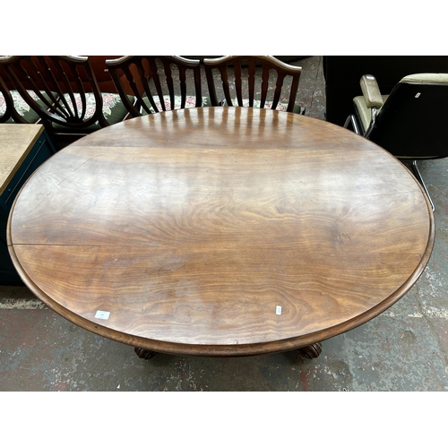 224 - A Victorian walnut oval tilt top breakfast table - approx. 75cm high x 115cm wide x 150cm long