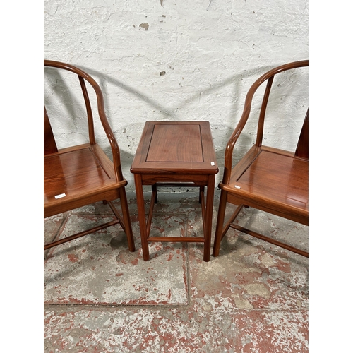 227 - A pair of Chinese hardwood horseshoe back chairs with side table