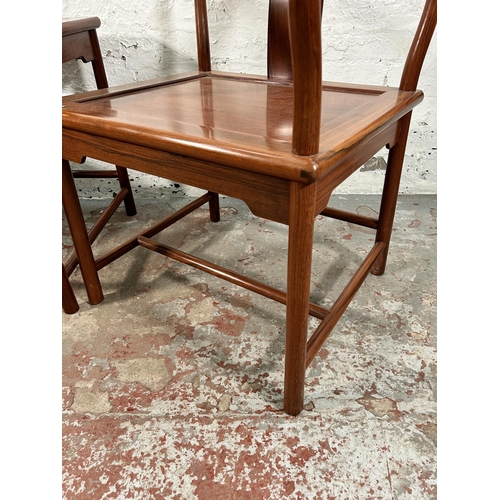 227 - A pair of Chinese hardwood horseshoe back chairs with side table