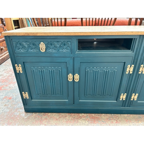 228 - A green painted oak linenfold sideboard converted TV stand - approx. 72cm high x 183cm wide x 47cm d... 