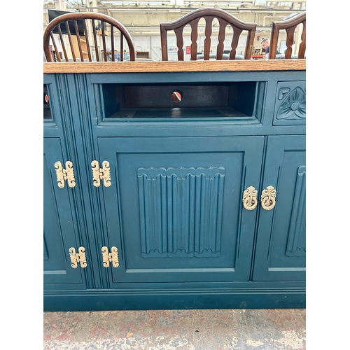 228 - A green painted oak linenfold sideboard converted TV stand - approx. 72cm high x 183cm wide x 47cm d... 