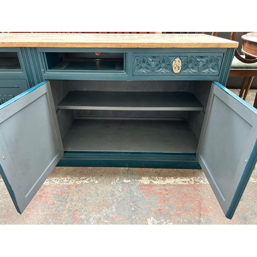 228 - A green painted oak linenfold sideboard converted TV stand - approx. 72cm high x 183cm wide x 47cm d... 