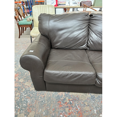 232 - A brown leather two seater sofa