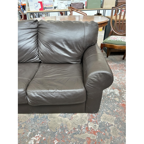 232 - A brown leather two seater sofa