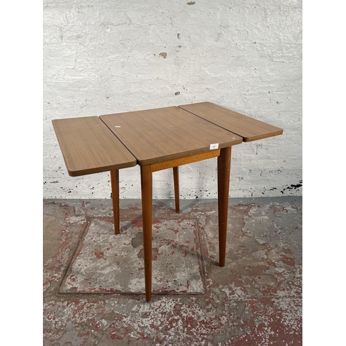 149 - A mid 20th century formica and beech drop leaf kitchen table