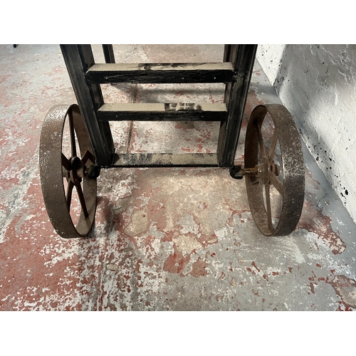 150 - A bespoke pine and black metal industrial style cart dining table - approx. 80cm high x 90cm wide x ... 