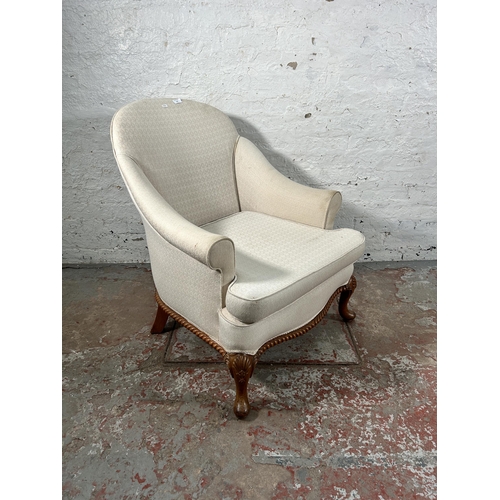 236 - A Georgian style white fabric upholstered and walnut armchair with cabriole supports and shell desig... 