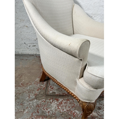 236 - A Georgian style white fabric upholstered and walnut armchair with cabriole supports and shell desig... 