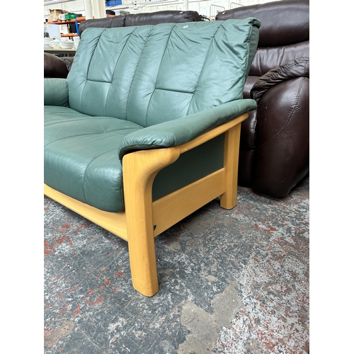 241 - An Ekornes Collection Stressless green leather and beech two seater sofa