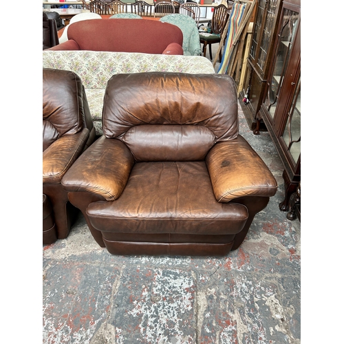 243 - A brown leather five piece lounge suite comprising two seater sofa, two armchairs and two footstools