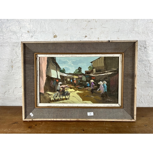 245 - A mid 20th century framed oil on canvas of an Oriental market scene, signed lower right - approx. 50... 