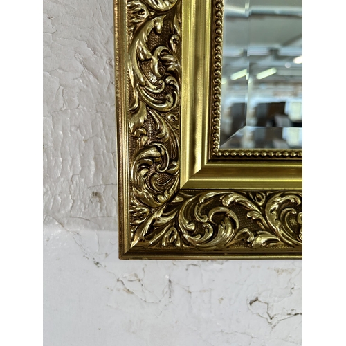 246 - A gilt framed bevelled edge wall mirror - approx. 71cm high x 101cm wide