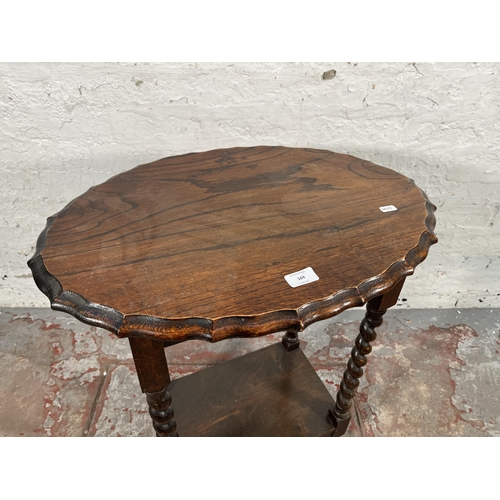 169 - An early/mid 20th century oak pie crust edge side table on barley twist supports