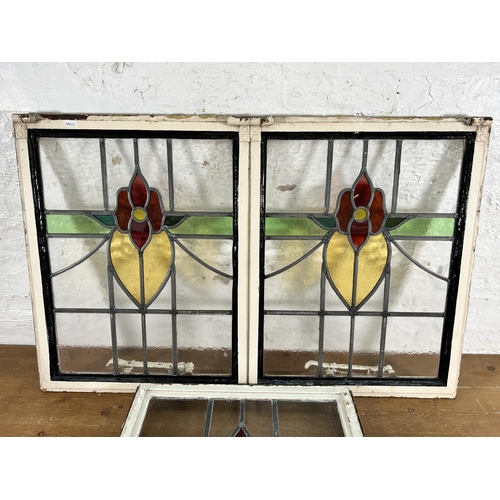 255 - Three 1930's steel framed stained glass windows - largest approx. 64cm high x 99cm wide