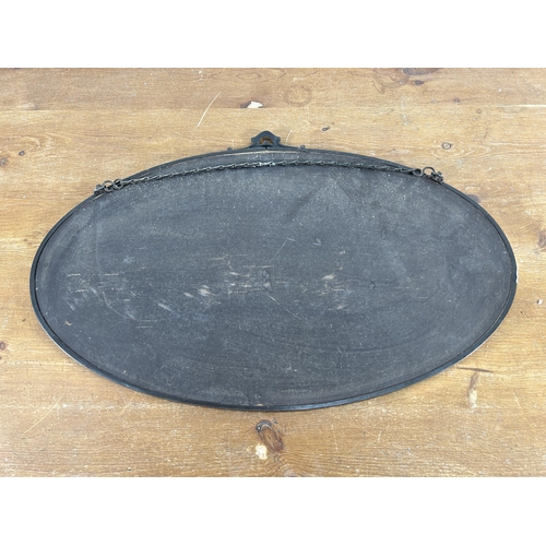 257 - An early 20th century copper framed bevelled edge oval wall mirror - approx. 42cm high x 66cm wide