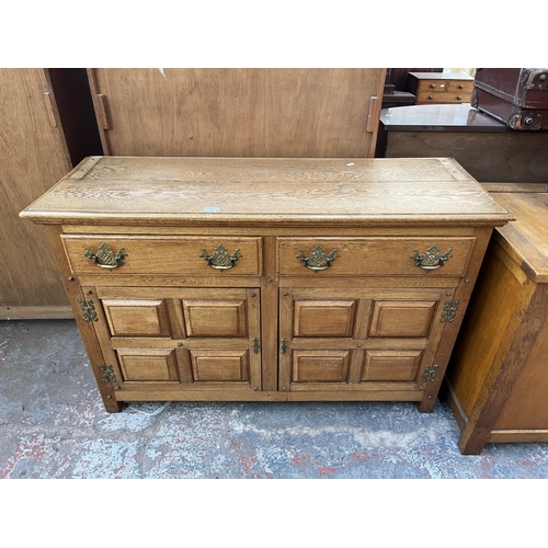 173 - An Arts & Crafts style panelled oak sideboard