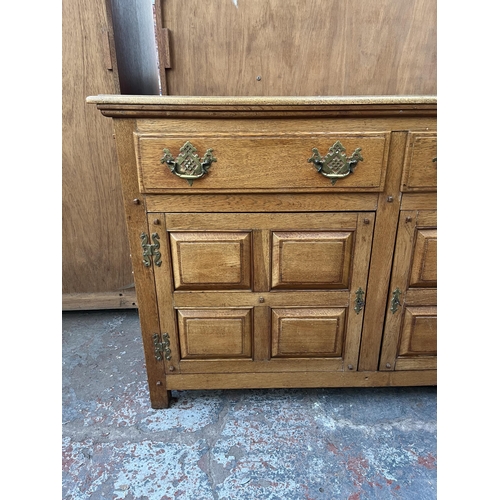 173 - An Arts & Crafts style panelled oak sideboard