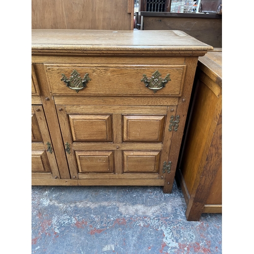 173 - An Arts & Crafts style panelled oak sideboard